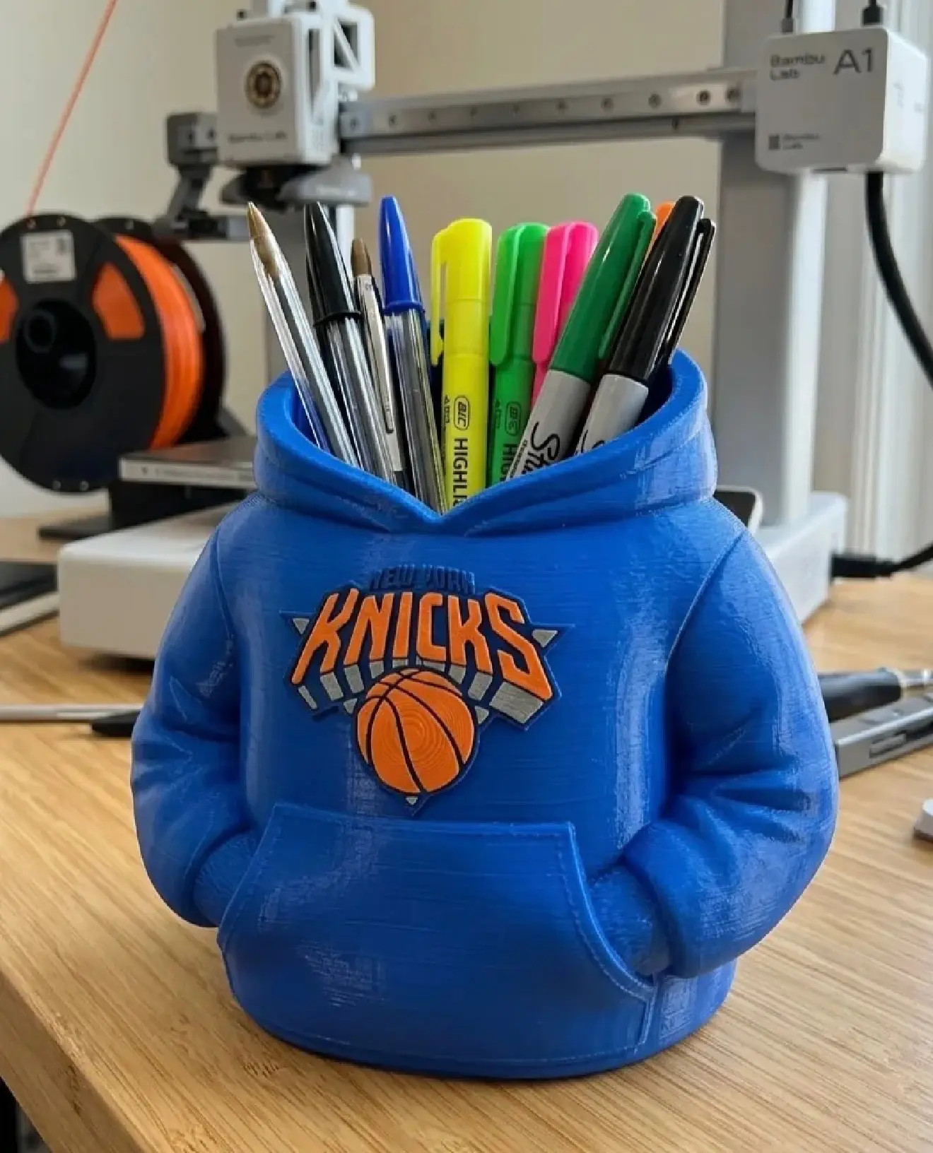 Custom 3D printed hoodie desk organizer holding pens and office supplies